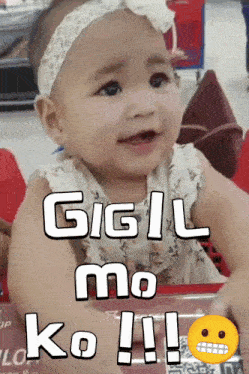 a baby is sitting in a shopping cart and says gigil mo ko