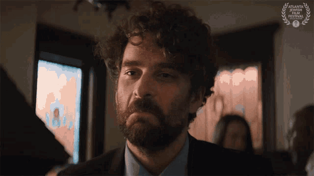 a man with a beard and a laurel wreath that says atlanta film festival