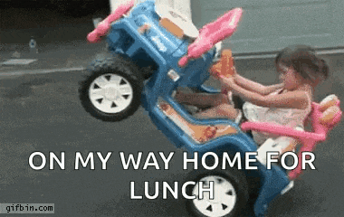 a little girl is riding in a toy car with the words on my way home for lunch .