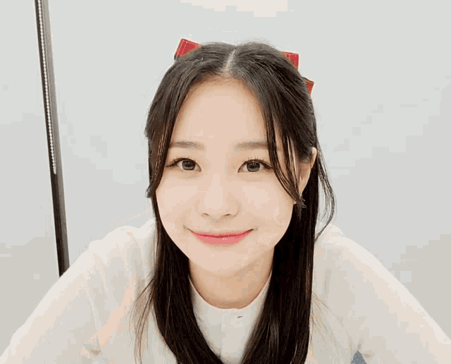 a girl with long black hair is making a funny face with her hands