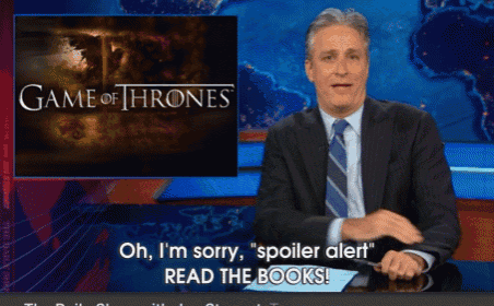 a man sitting in front of a game of thrones poster