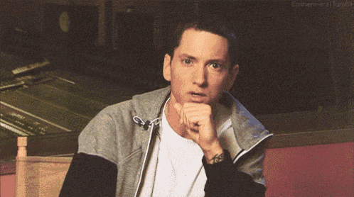 a close up of a man 's face with the word eminem on the bottom left