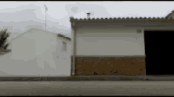 a blurry picture of a white house with a black door