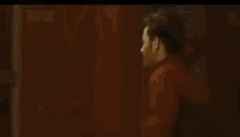 a man is running in front of a brick building