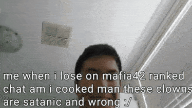 a man is standing in front of a ceiling fan with a caption that says me when i lose on mafia