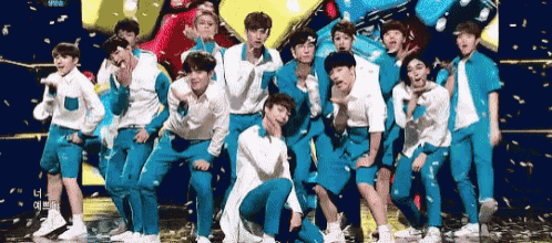 a group of young men are posing for a photo on a stage .