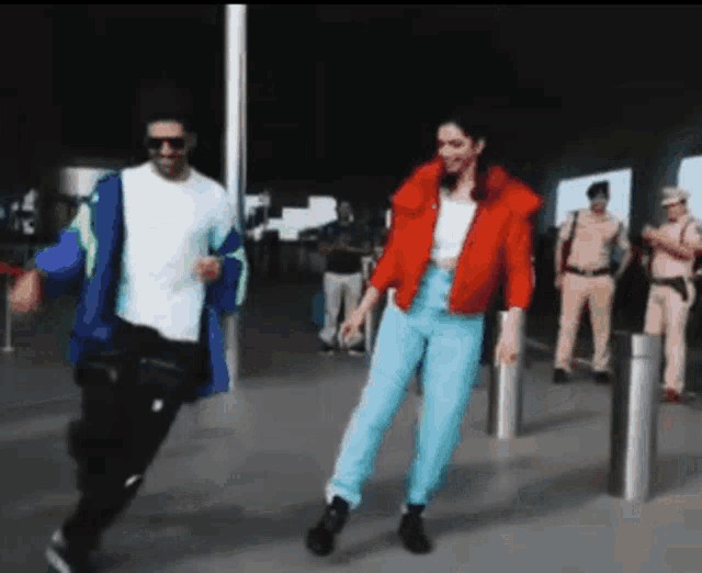 a man and a woman are dancing in front of a group of police officers