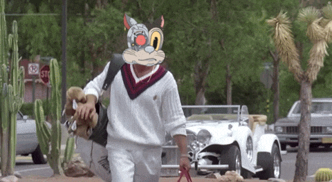 a man wearing a sweater with a cartoon cat face on it