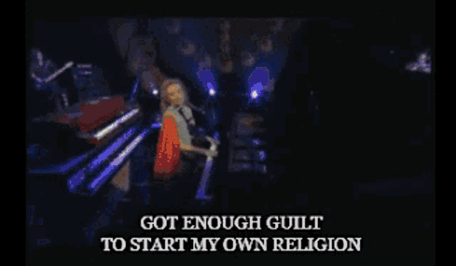 a woman singing into a microphone with the words got enough guilt to start my own religion above her
