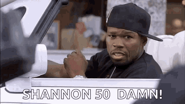 a man in a hat is sitting in a car and says shannon 50 damn