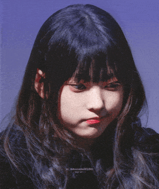 a close up of a girl 's face with a blue sky in the background and a watermark that says avocado0518hr