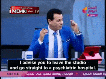 a man in a blue suit and tie is talking on a tv channel