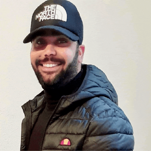 a man wearing a black hat that says " the north face "