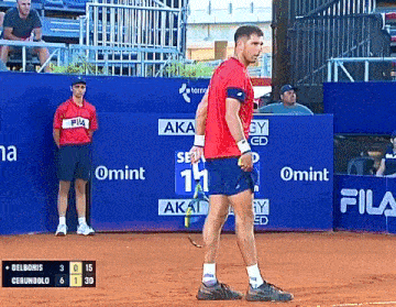 a man in a red shirt with fila on it