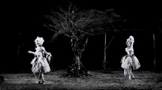 a black and white image of two ghosts dancing