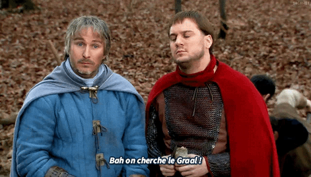 a man in a red cape says bah on cherche le graal while standing next to another man