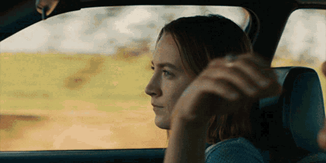 a woman in a car looking out the window