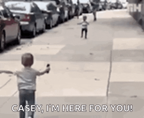 a young boy is riding a bike down a sidewalk and says `` casey , i 'm here for you '' .