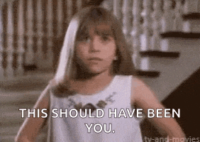 a young girl in a white dress is standing in front of stairs and says `` this should have been you '' .