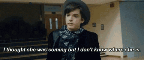 a young boy wearing a hat and scarf is standing in a hallway with a quote .
