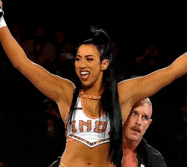 a female wrestler is wearing a top that says nb on it