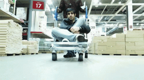a man sits on a cart in front of a sign that says ages 17