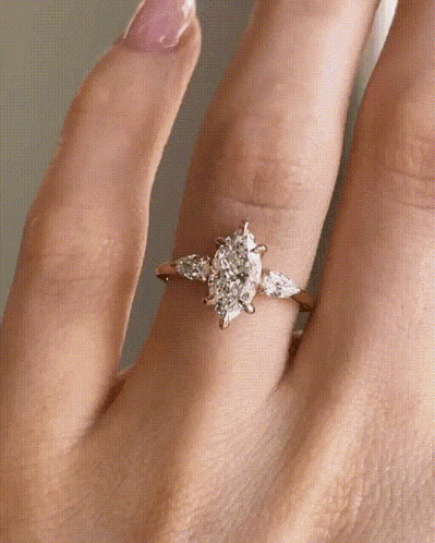 a woman is wearing a ring on her left hand