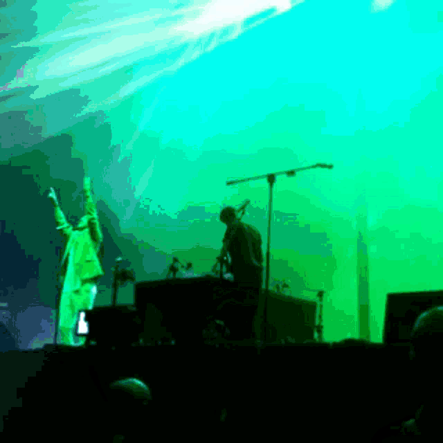 a man singing into a microphone on a stage