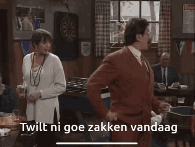 a man in a red suit is dancing in a room with the words " twit ni goe zakken vandaag " written on the bottom
