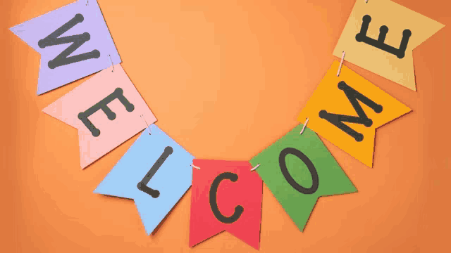 a bunch of colorful flags with the word welcome on them