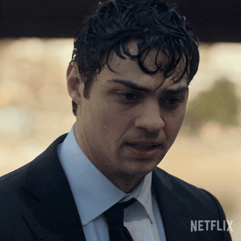 a man in a suit and tie with a netflix logo on the bottom right