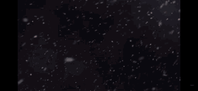 a red lizard is swimming in the water with snow falling