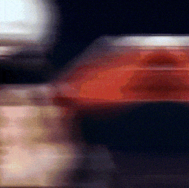 a blurred image of a red object with a black background