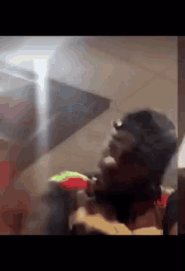 a blurry picture of a man sitting on a couch