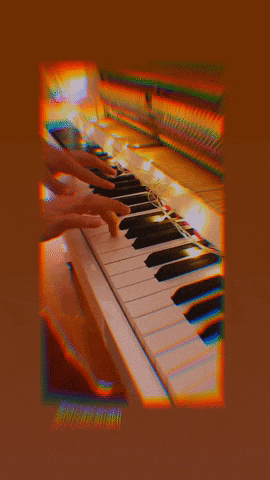 a blurry picture of a person playing a piano keyboard
