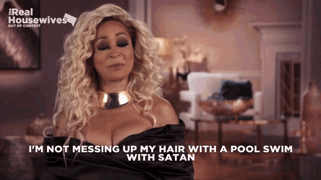 a woman says i 'm not messing up my hair with a pool swim with satan on the screen