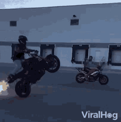 a man is doing a trick on a motorcycle with a flame coming out of the tire .