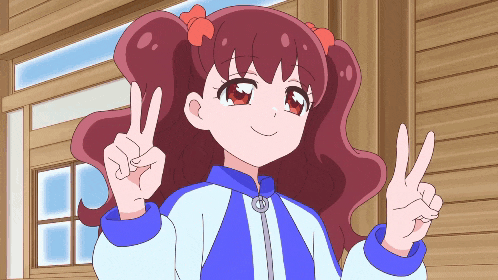 a girl in a blue and white jacket giving the peace sign