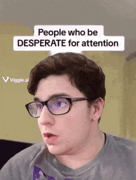 a man wearing glasses and a t-shirt with a sticker that says people who be desperate for attention