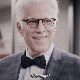 a man in a suit and bow tie is smiling and laughing .