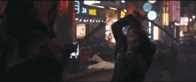 a man walking down a street with a sign that says 24 hrs