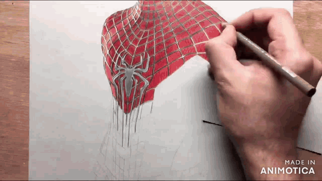 a person is drawing a spider man costume on a piece of paper with a marker
