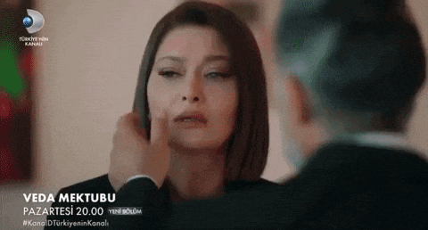 a man is touching a woman 's face in a scene from a tv show .
