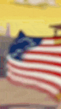 a blurry picture of an american flag with a mountain in the background