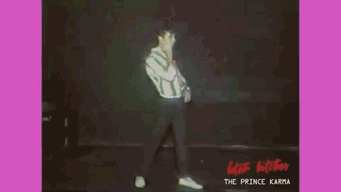 a group of people are dancing in front of a sign that says the prince karma .