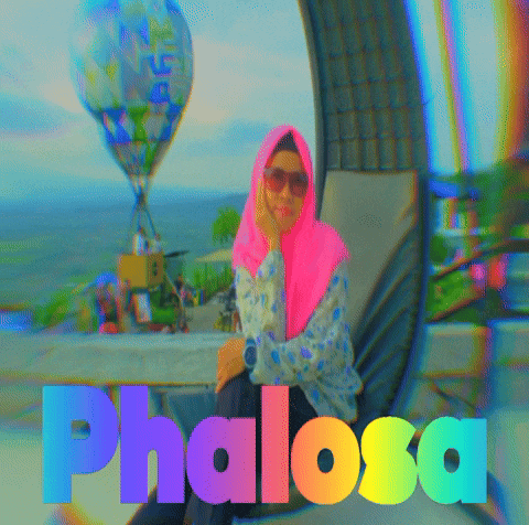a woman in a pink head scarf is sitting in front of a hot air balloon and the word phalosa is visible