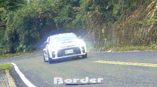a car is driving down a road with the word border on the bottom right