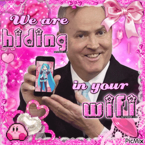 a man in a suit and tie is holding a cell phone with a picture of hatsune miku on it