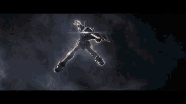 a close up of a person holding a gun in a dark room