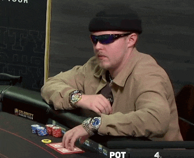 a man sits at a poker table with a sign that says celebrity poker tour on it